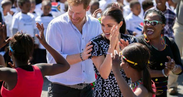 Britain’s  Duchess of Sussex and Prince Harry (L), the Duke of Sussex, dance during a visit to Nyanga township in Cape Town, South Africa. Photograph: Facundo Arrizabalaga/EPA
