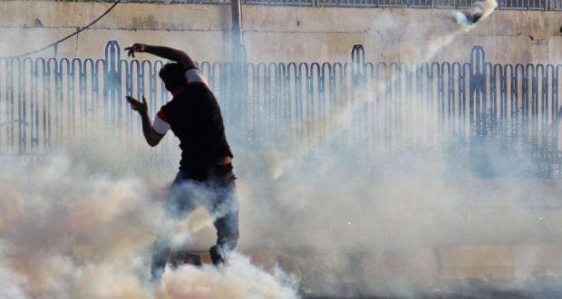 An Iraqi demonstrator gestures amidst smoke from burning tyres and tear gas during a demonstration in Baghdad  on Satruday. Photograph: Ahmad al-Rubaye/AFP via Getty 