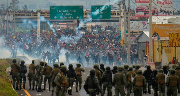 Demonstrators and riot police clash in Quito on Monday following days of protests against the sharp rise in fuel prices following the authorities’ decision to scrap subsidies. Photograph: Rodrigo Bundia/AFP via Getty Images