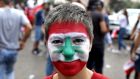 Lebanese woman with a national flag painted on her face taking part in a rally in Beirut on October 20th on the fourth day of demonstrations against tax increases and corruption. Photograph: Patrick Baz/AFP