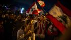 Anti-government protesters wave the flag of Lebanon as they gather in Martyr’s Square in Beirut on Tuesday night. Photograph: Diego Ibarra Sanchez/New York Times