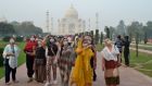 Foreign tourists wearing face masks visit the Taj Mahal under heavy smog conditions in Agra on Monday. Photograph: Jewel Samad/AFP via Getty Images