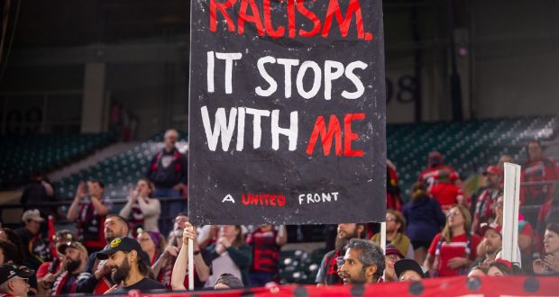  Portland Thorns supporters display a sign against racism in Oregon after their goalkeeper Adrianna Franch suffered racial abuse during an  away match in Salt Lake City, Utah. Photograph:  Diego Diaz/Icon Sportswire via Getty Images.