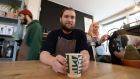 Niall Wynn, owner  of the Proper Order Coffee Company in Dublin’s Smithfield, with one of his compostable coffee cups. Photograph: Alan Betson