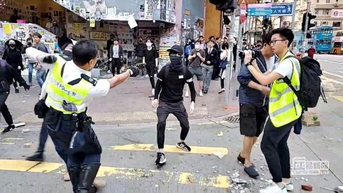 UNREST CONTINUES: A still image from a social media video shows a police officer aiming his gun at a protester in Hong Kong.  Photograph: Cupid Producer/Reuters