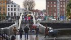 Pedestrians walking over Ha’penny Bridge, the main access point to the touristic area of Temple Bar. Photograph: iStock 