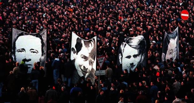 Pictures of the victims of Bloody Sunday being carried through the crowd of thousands after the 25th anniversary march for Bloody Sunday in Derry. Photograph: Brian Little/PA