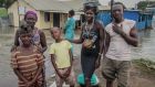 Akwero Beatrice, her sister Alaker and their children have been forced to leave their home, which is waist-deep in water. They are moving to a relative’s house but do not know how they will survive long term. Photograph: Sally Hayden 
