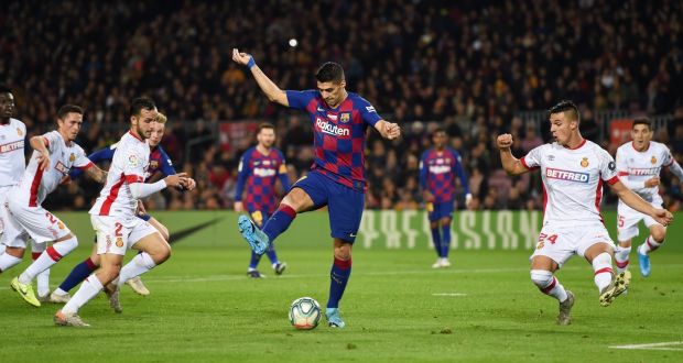 Luis Suarez scores Barcelona’s fourth goal with a backheel during the La Liga match against Mallorca at  the Nou Camp. Photograph:  Alex Caparros/Getty Image