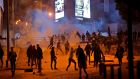 Supporters of Lebanon’s Shia Hizbullah and Amal groups clash with riot police in central Beirut. Photograph: Getty