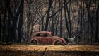The remains of a car  destroyed by bushfires sits near a home in the town of Balmoral on Monday  in Sydney, Australia. Photograph: Getty 