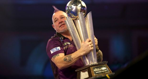 Peter Wright celebrates with the trophy after winning the William Hill World Championships at Alexandra Palace by beating Michael van Gerwen in the final. Photo: Steven Paston/PA Wire