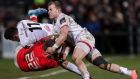 Munster’s Dan Goggin is tackled by Jacob Stockdale and Will Addison of Ulster during the Guinness Pro 14 game at the Kingspan stadium in Belfast. Photograph: Laszlo Geczo/Inpho