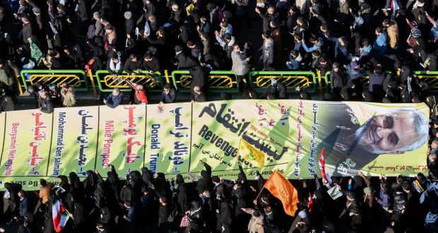 A banner bearing the likeness of  Qassem Suleimani is carried during a funeral procession in Tehran, Iran. Photograph: Arash Khamooshi/The New York Times