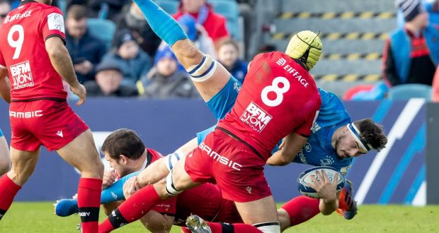 Leinster’s Max Deegan is tackled by Francisco Gomez Kodela and Virgile Bruni of Lyon during the Heineken Champions Cup game at the  RDS. Photograph: Morgan Treacy/Inpho 