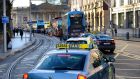 Under the plaza plans, public transport traffic, including trams, buses and taxis, would continue to run north and south in front of Trinity College to access Nassau Street. File photograph: The Irish Times