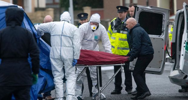 Gardaí remove the remains on Tuesday morning at the scene of the discovery of human body parts at the junction of Moatview Gardens and Moatview Drive in Darndale, Dublin,  on Monday night. Photograph: Colin Keegan, Collins 