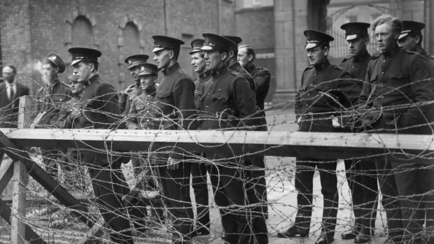 Members of the Black and Tans, an armed auxiliary force of the Royal Irish Constabulary, and British army privates watch fighting at the siege of the Four Courts in June 1922. Photograph: Topical Press Agency/Getty