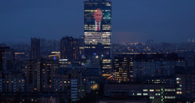 An electronic screen, installed on the facade of a business centre, shows an image of Russian president Vladimir Putin. Photograph: Anton Vaganov/Reuters