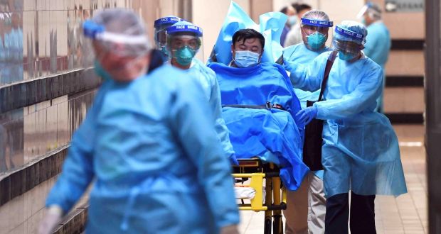 Medical staff transfer a patient of a highly suspected case of a new coronavirus at the Queen Elizabeth Hospital in Hong Kong on Tuesday. Photograph: Cnsphoto via Reuters