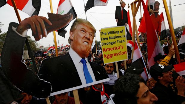 Supporters of Shia cleric Muqtada al-Sadr carry placards depicting US president Donald Trump. Photograph: Alaa al-Marjani/Reuters