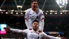 Liverpool’s Alex Oxlade-Chamberlain celebrates scoring his side’s second goal of the game with team-mate Roberto Firmino during the Premier League match against West Ham at London Stadium.  Photograph: Adam Davy/PA Wire