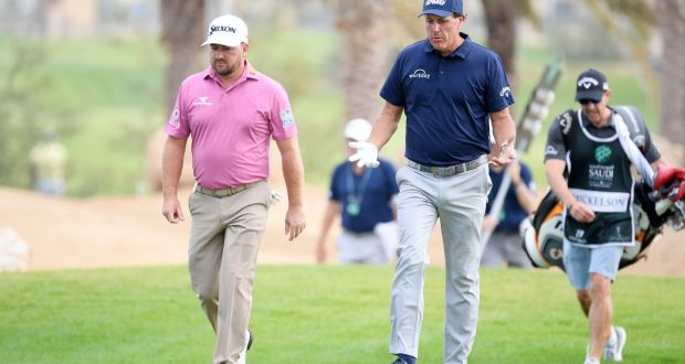  Graeme McDowell  and Phil Mickelson  walk along the 14th hole during the second round of the  Saudi International at Royal Greens Golf and Country Club in King Abdullah Economic City, Saudi Arabia. Photograph: Ross Kinnaird/Getty Images