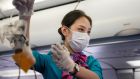  A flight attendant of Cambodian Lanmei Airlines demonstrates safety procedures in the airplane while wearing a face mask during a flight from Cambodia to Guangzhou, China. Photograph: Alex Plavevski/EPA