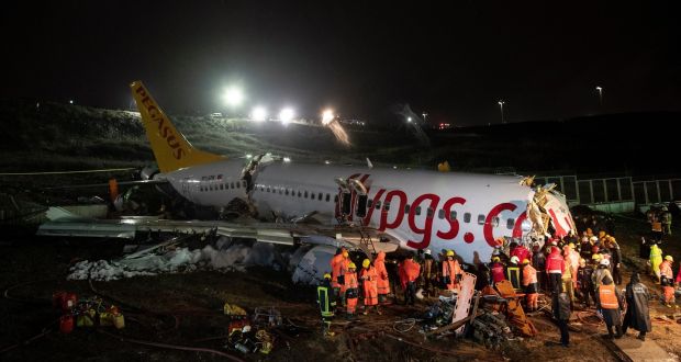 Emergency services workers evacute passengers after a Pegasus Airlines plane skidded off the Sabiha Gokcen airport runway in Istanbul, Turkey, on Friday. Photograph: EPA