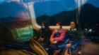 MTR train passengers in Hong Kong wearing masks: The UK has warned its citizens to report flu-like symptoms if flying back from nine Asian countries. Photograph: Billy HC Kwok/New York Times