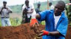 A Burundian worker from the Truth and Reconciliation Commission at a mass grave in Karusi province. Photograph: Evrard Ngendakumana/Reuters