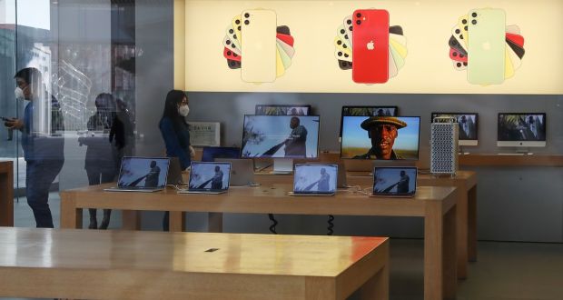 Employees wear face masks at Apple Store in Beijing.  Photograph:  Lintao Zhang/Getty Images
