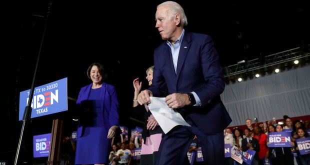 Democratic presidential candidate former vice-president Joe Biden chases notes for former rival senator Amy Klobuchar during a campaign stop in Dallas, Monday, March 2nd, 2020. Photograph: Eric Gay/AP
