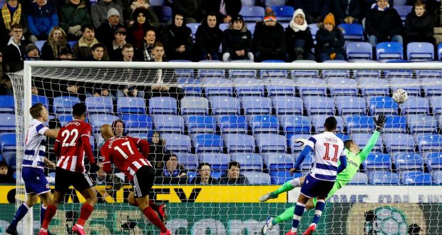 Sheffield United’s  David McGoldrick heads home to score the opening goal in the FA Cup fifth-round  match against Reading at the Madejski stadium. Photograph: Adrian Dennis/AFP via Getty Images