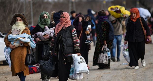 Migrants carry belongings towards the Pazarkule border gate in Edirne in northwest Turkey as they try to enter Europe. Photograph: Ozan Kose/AFP