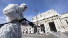  Operators of the Milanese Environmental Services Company (AMSA) sanitise the square of the Central Station using a disinfectant diluted water to avoid further spread of the COVID-19 on Friday. Photograph: Marco Ottico/EPA