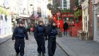 Garda public order unit in Temple Bar as pubs in that area of Dublin close in interest of public health on Sunday. Photograph: Dara Mac Dónaill
