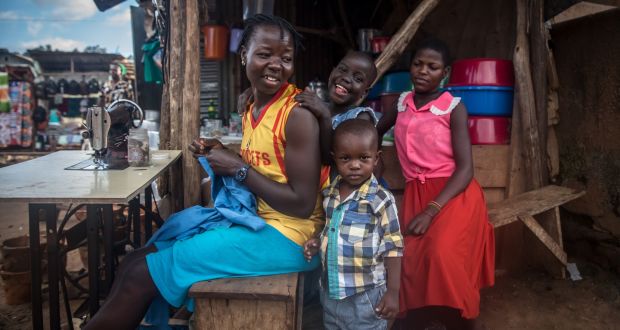 Tailor Mama Ojara (28) lives in one room with five others in Namuwongo, Kampala. Photograph: Sally Hayden