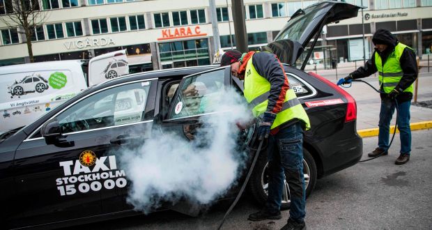 A taxi is cleaned and disinfected in Stockholm, Sweden. Photograph: Getty