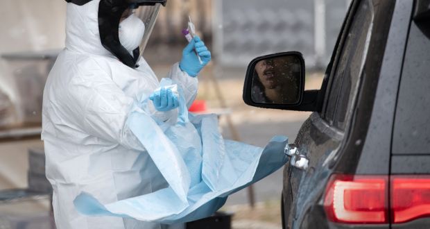 A nurse dressed in personal protective equipment  prepares to give a coronavirus swab test at a drive-through testing station  in Stamford, Connecticut. Criminals across Europe are exploiting shortages of masks, respirators, and other essential medical equipment for illicit profit. Photograph: John Moore/Getty Images