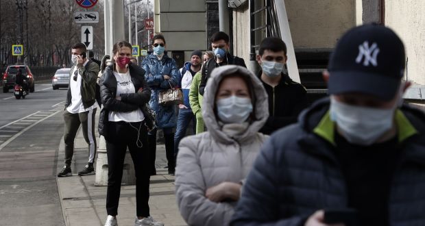 People wearing medical face masks stand in line for testing of the coronavirus disease,  in Moscow, on Friday. Photograph: Maxim Shipenkov/EPA
