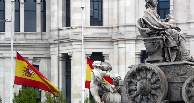 The Spanish flag flutters at half mast next to the Cibeles fountain in Madrid. Message reads: “Thank you. I stay home”. Photograph: Sergio Perez/Reuters