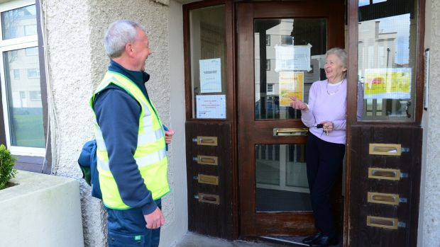 Postman Joe McDonald chats to Rose outside her home. Photograph: Bryan O’Brien