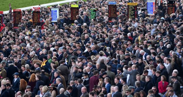Racegoers attend the final day of the Cheltenham festival. Photograph:  Glyn Kirk/AFP via Getty Images
