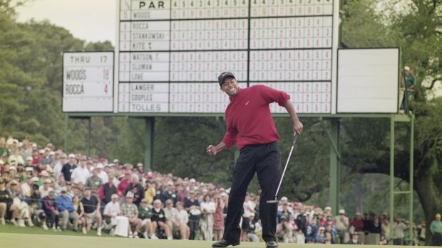 Tiger Woods celebrates his first Masters win in 1997 after sinking a four-foot putt to win the tournament with a record low score of 18 under par. Photograph: Stephen Munday/Allsport/Getty Images
