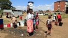  Residents fetch water from a bore hole in Mbare, Zimbabwe, during a nationwide lockdown on Wednesday. Photograph: Aaron Ufumeli/EPA