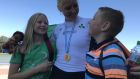 Sanita Puspure with her children Daniella and Patrick and her World Championship gold medal in 2018. Photo: Liam Gorman