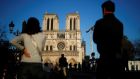 People listen to the Notre-Dame de Paris Cathedral’s great bell ringing, one year after a devastating fire at the building. Photograph: Gonzalo Fuentes/Reuters