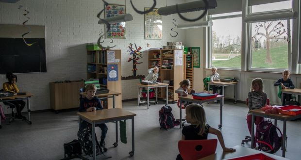 Primary school children sit at desks spaced about two yards apart, in Logumkloster, Denmark. Photograph: Emile Ducke/The New York Times