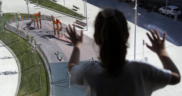 A girl looking at a deserted playground from her window in Bilbao, northern Spain. Photograph:  EPA/Luis Tejido